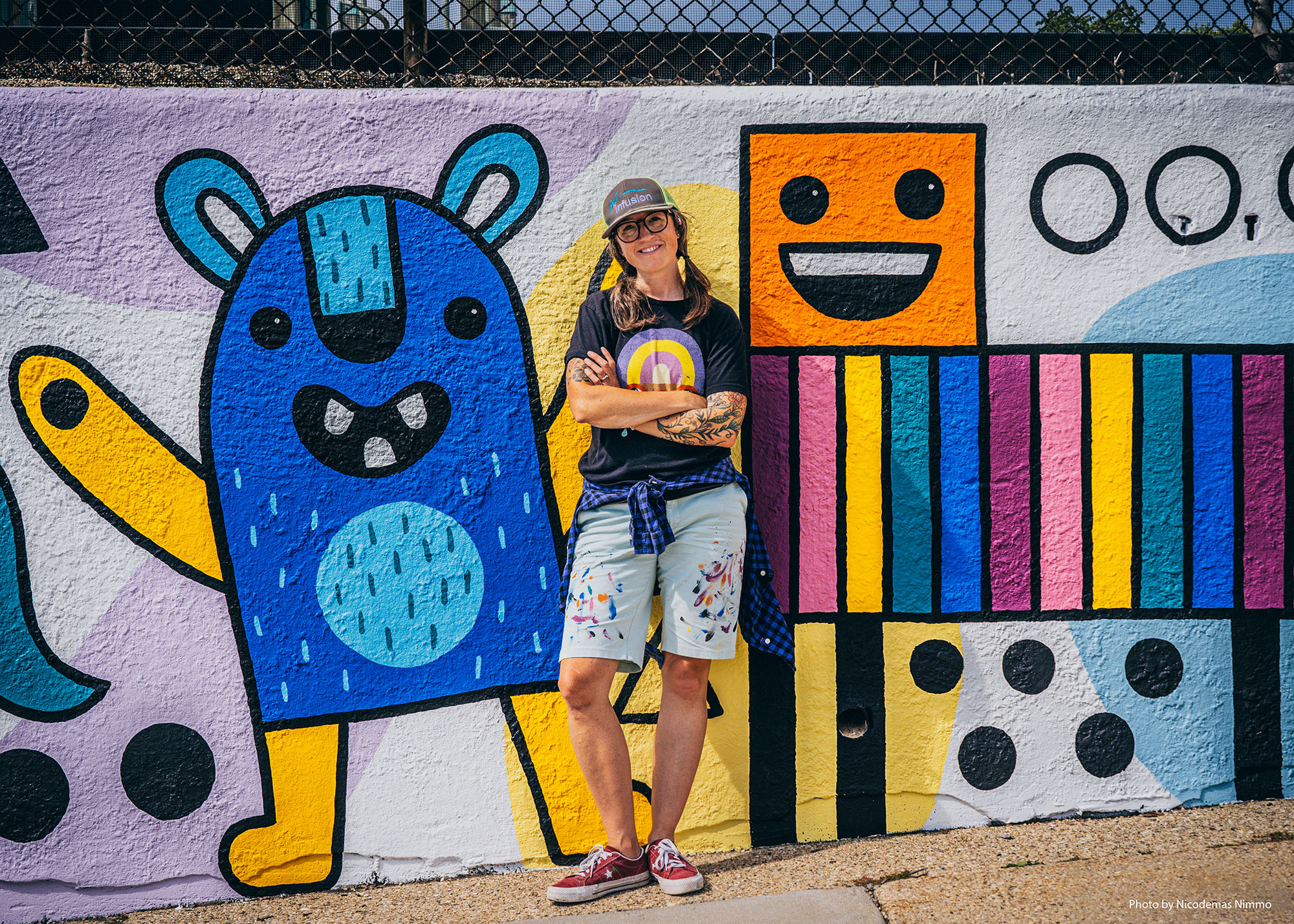 Artist Emily Balsley in front of a mural she painted