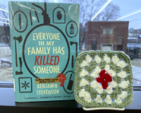 the book Everyone in my Family Has Killed Someone next to a green white and red crocheted granny square