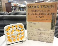 Adventures of Huckleberry Finn with white and yellow granny square