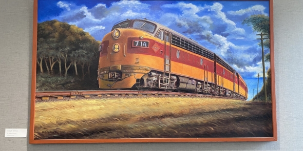 Large painting of a Milwaukee Road train with engine and passenger cars.