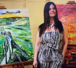 Nancy Dimicelli with two of her paintings