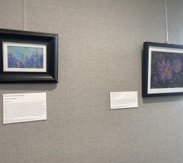 Two oil pastels paintings depicting blue and purple flowers