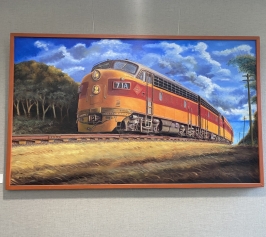 Large painting of a Milwaukee Road train with engine and passenger cars.