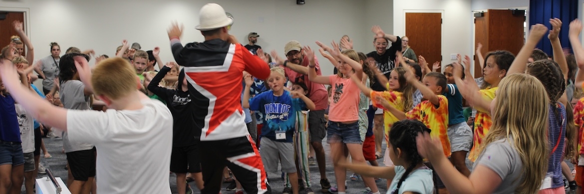 Children and instructor dancing in a group