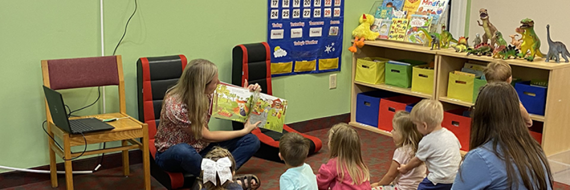 Storytime event showing librarian reading to a group of children